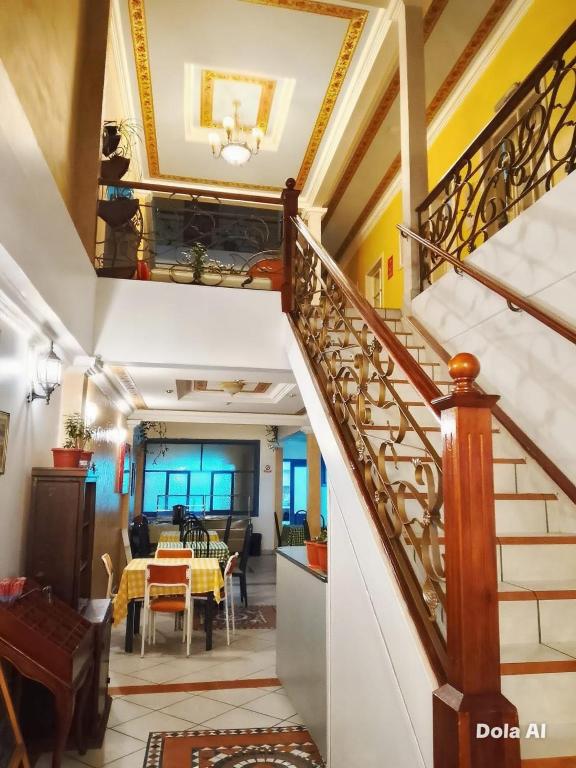 a staircase in a house with a dining room at Hotel Grer By Chat Noir in Cuenca