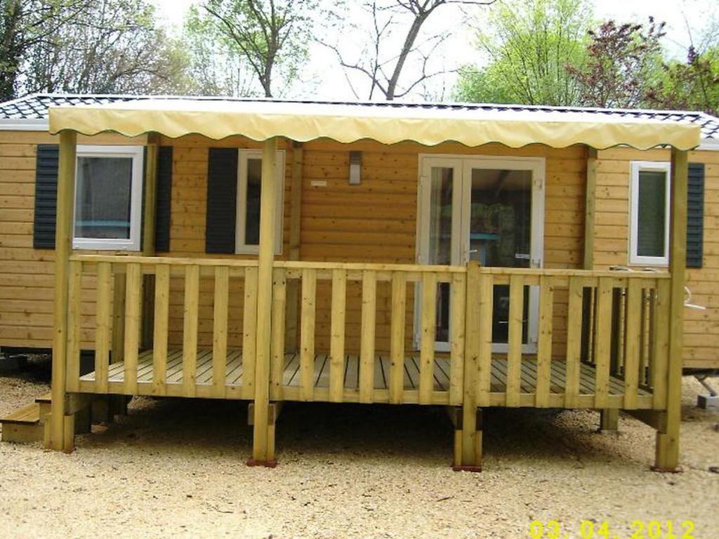 a large wooden cabin with a large deck at Mobil-home avec Terrasse à Salavas - API-1-52-1151 in Vallon-Pont-dʼArc