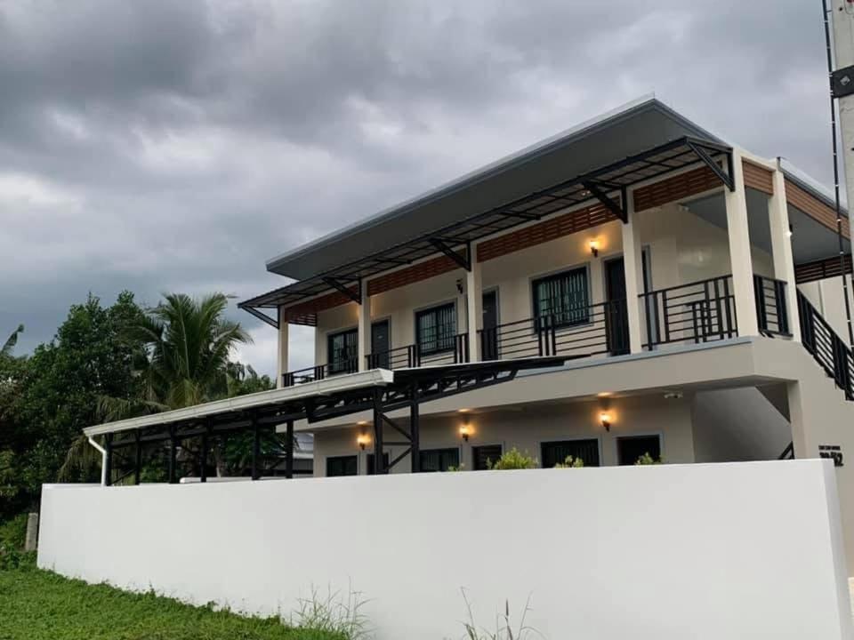 a white fence in front of a house at ZAMZAM House in Thalang