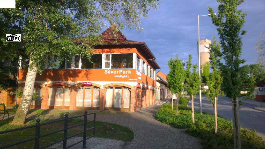 a building with a sign on the side of it at Silver Park Vendégház in Berettyóújfalu