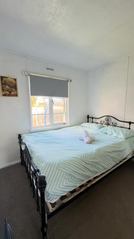 a large bed in a room with a window at Private Double Room close CBD & Airport in Warrane