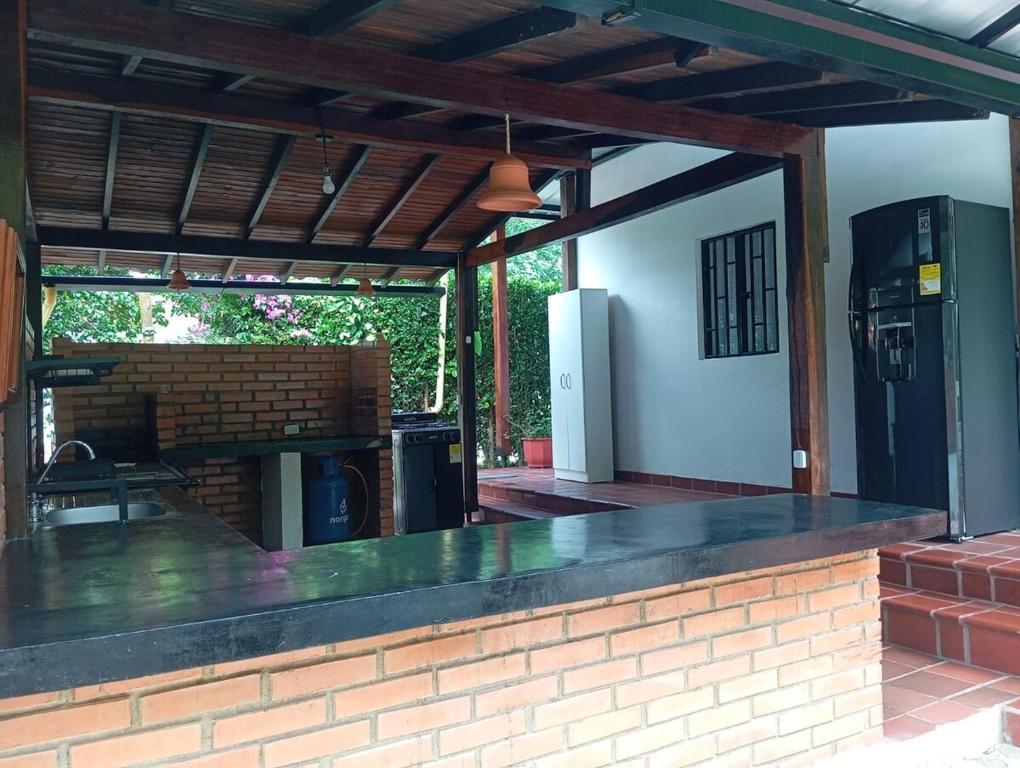 una cocina al aire libre con bar y chimenea en El Molino - Your perfect getaway awaits you here!, en Pamplonita