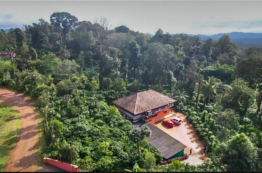 an overhead view of a house in the middle of a forest at KOORGI RETREAT- Coorg in Napoklu