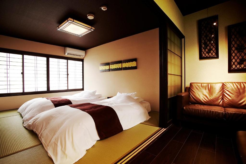 a bedroom with a large bed and a couch at Kyoto Senraku in Kyoto