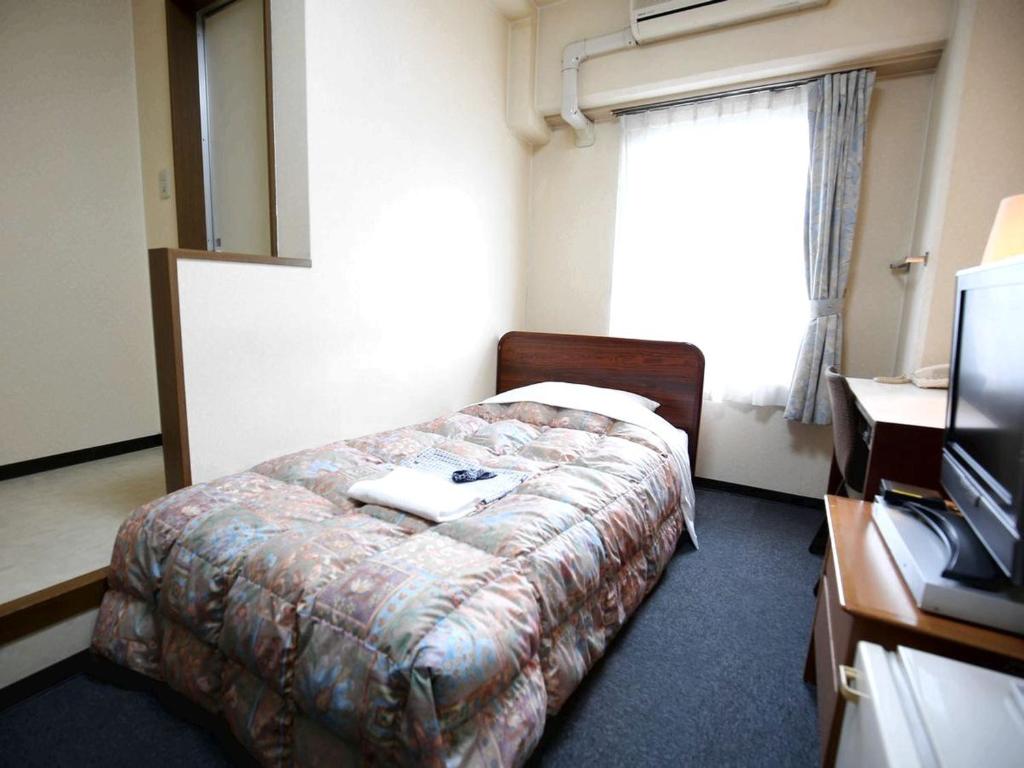 Postel nebo postele na pokoji v ubytování Hotel Sun Plaza Sakai