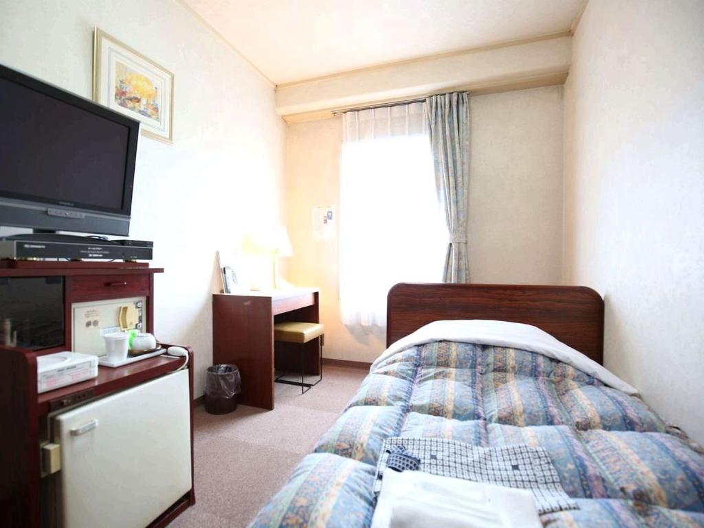 Postel nebo postele na pokoji v ubytování Hotel Sun Plaza Sakai