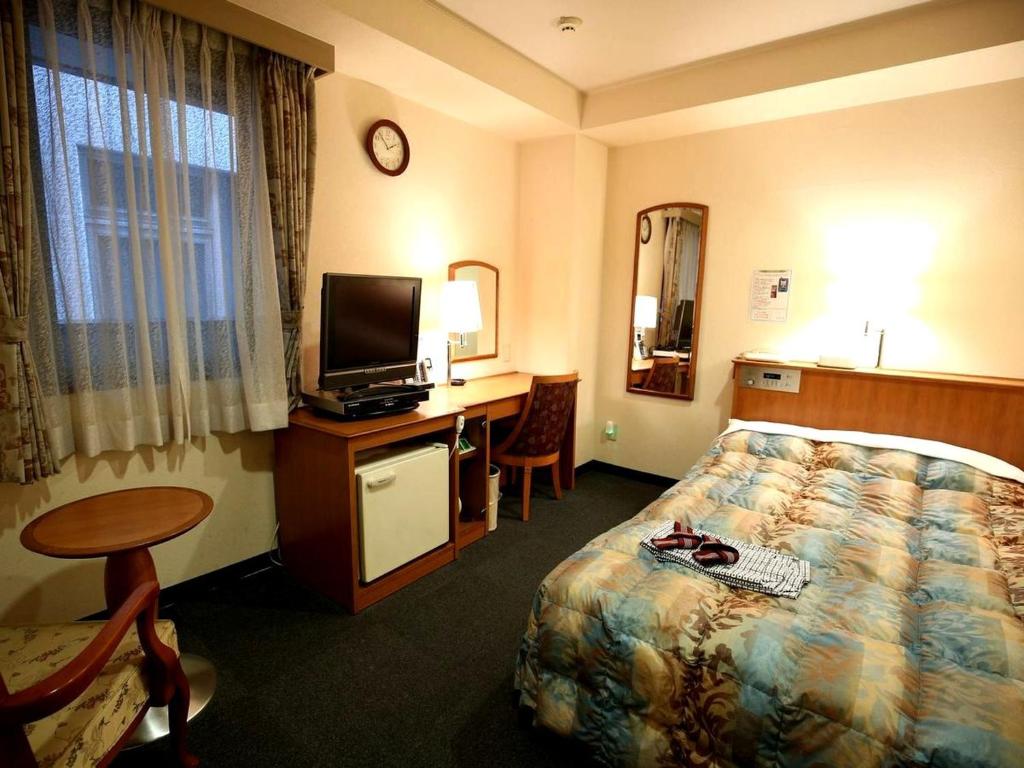 Postel nebo postele na pokoji v ubytování Hotel Sun Plaza Sakai