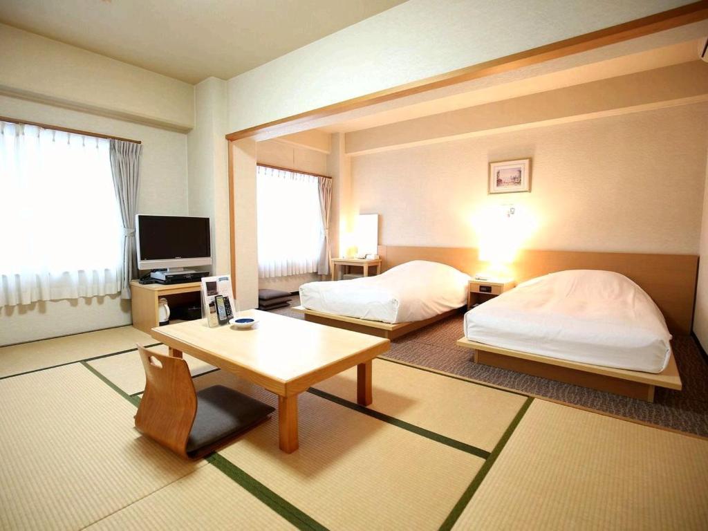 Postel nebo postele na pokoji v ubytování Hotel Sun Plaza Sakai