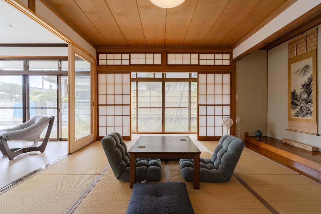 a living room with a table and chairs at Hakoshimizu Retreat - 10mins walk to Zenkoji in Nagano