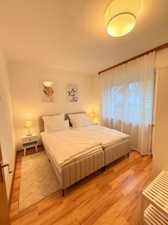a bedroom with a large bed and a window at Gemütliche 2 Zimmer Wohnung Bad Steben in Bad Steben