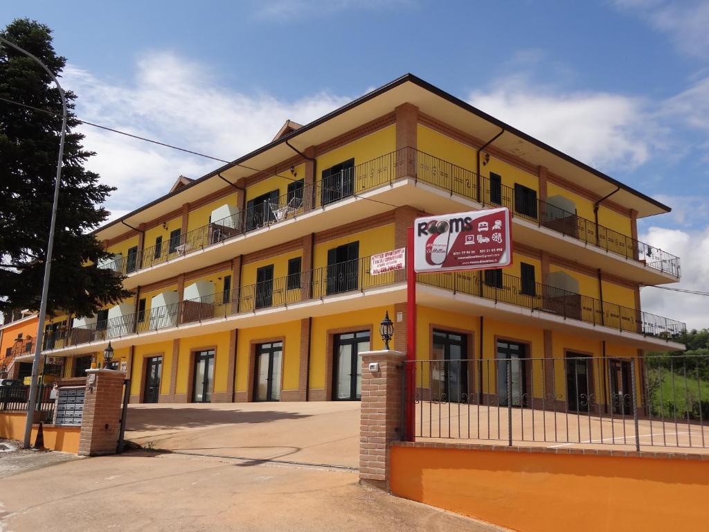 a yellow building with a no smoking sign in front of it at Affittacamere Rooms Di Matteo in San Paolo di Iesi