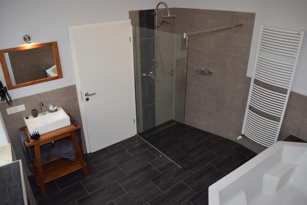 a bathroom with a shower and a sink at Hotel - Bistro - 3-Eck in Merchweiler