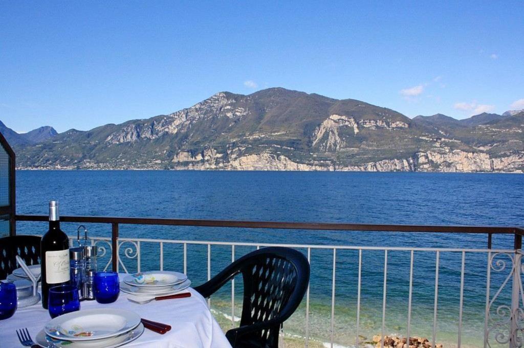 a table with a view of the ocean and mountains at Casa Manu in Brenzone sul Garda