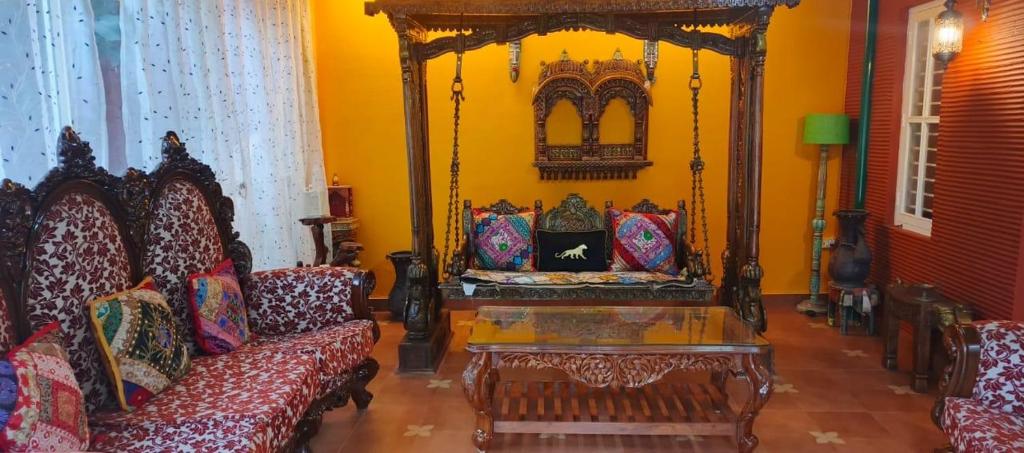 een woonkamer met een bank en een groot bed bij Loto Villa in Bangalore