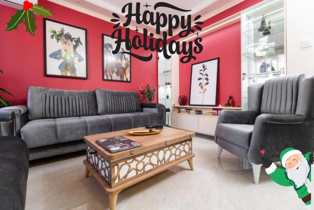 a living room with a christmas sign on the wall at Modern & Elegant City Center Apartments in Plovdiv