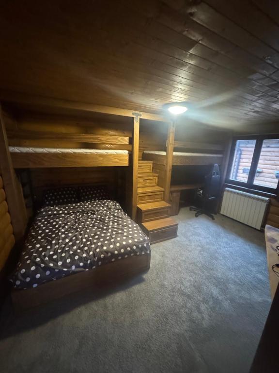 a bedroom with a bunk bed in a room at Kosmajska Bajka in Rogača