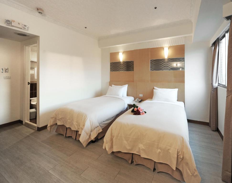 Rúm í herbergi á Kenting Holiday Hotel