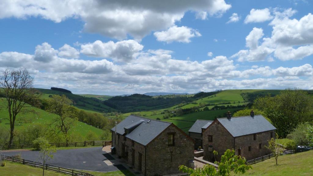 an aerial view of an old house in the hills at Beacons View Farm Cottages in Merthyr Cynog