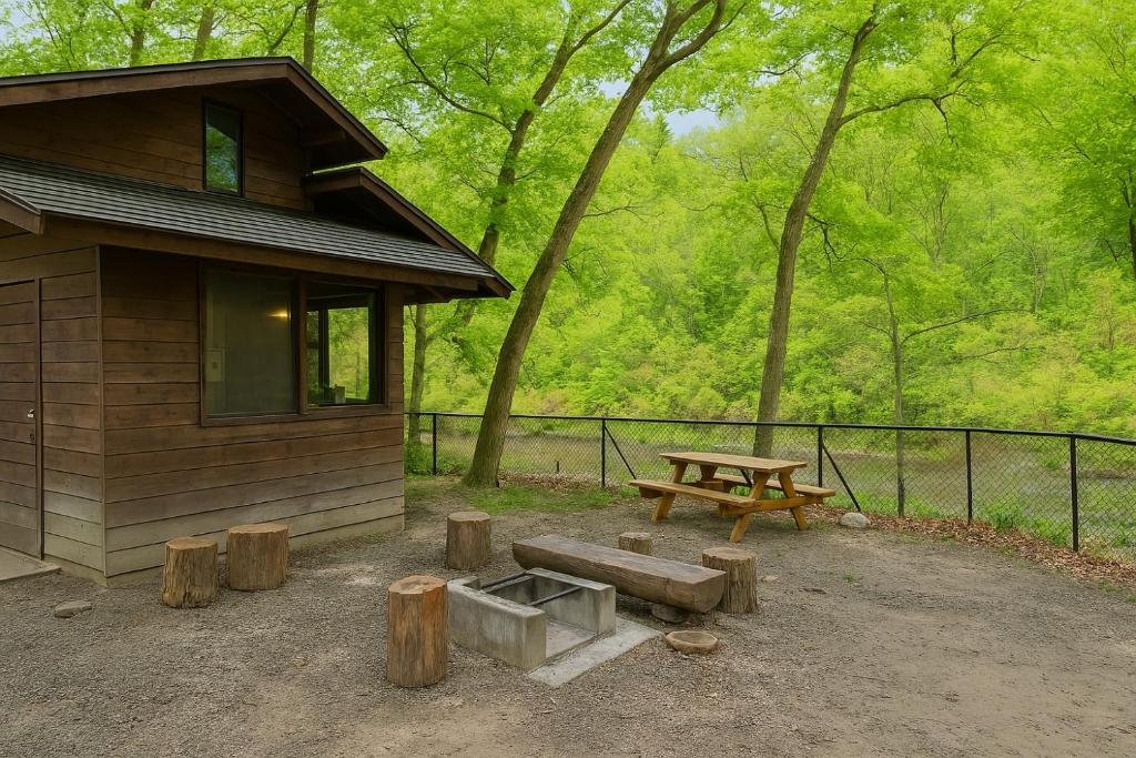 a wooden cabin with a picnic table and a bench at 秋保木の家ロッジ村 in Sendai