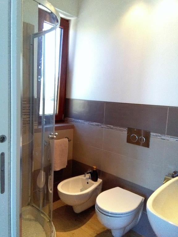 łazienka z toaletą, umywalką i prysznicem w obiekcie La Casetta Holiday Home w mieście Alghero