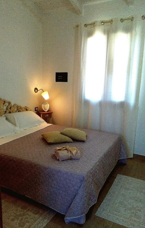 Łóżko lub łóżka w pokoju w obiekcie La Casetta Holiday Home