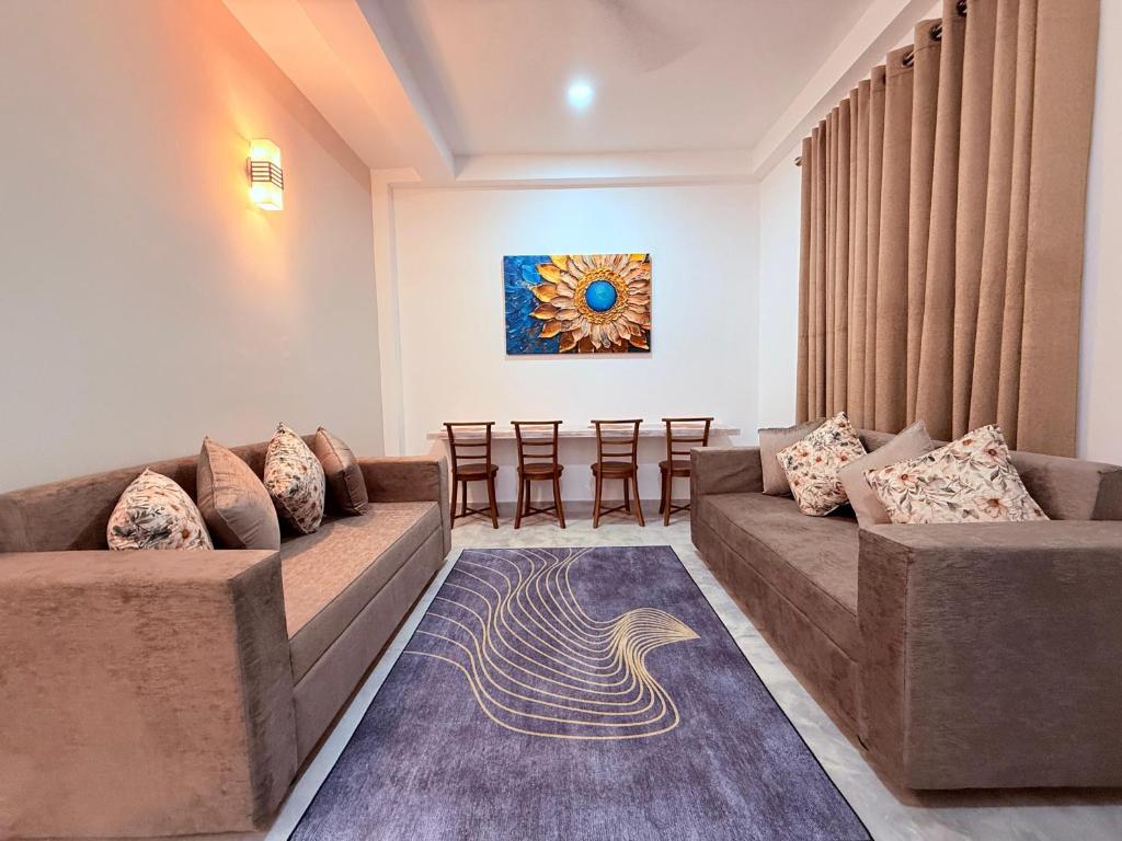 a living room with two couches and a painting at Urban Oasis Residence in Nugegoda