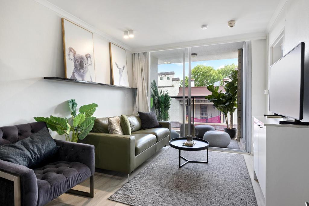 Et opholdsområde på Stylish 1-Bedroom Stay with Balcony & Amenities