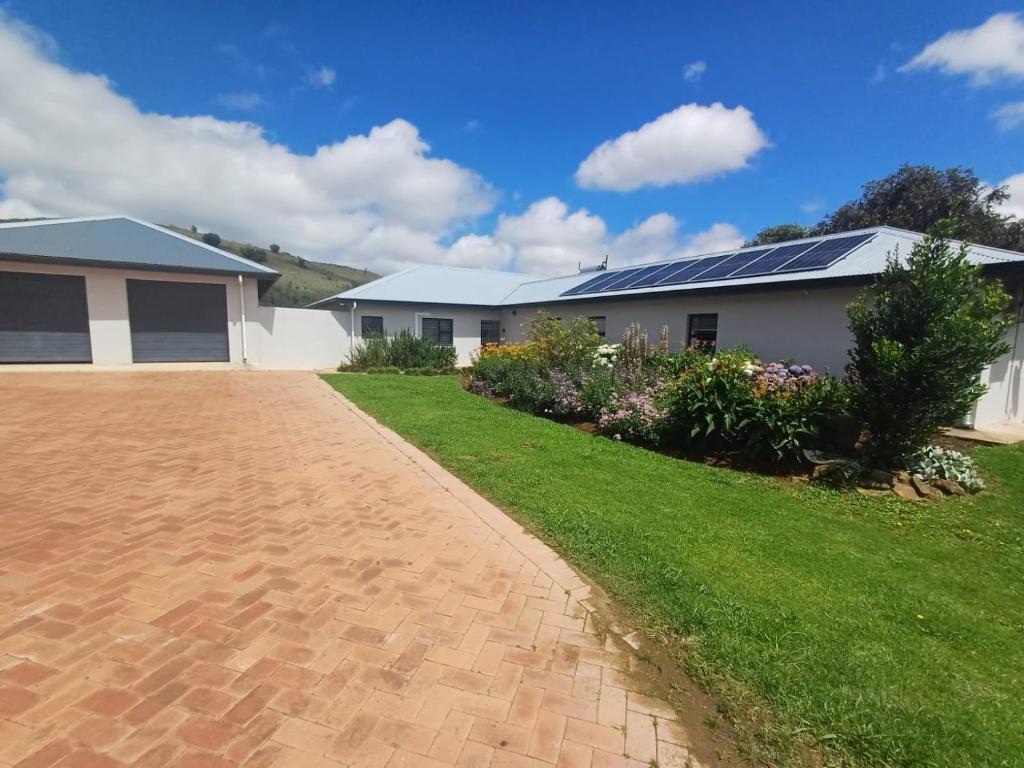 a house with solar panels on the roof at Carshalton Cottage in Mooirivier