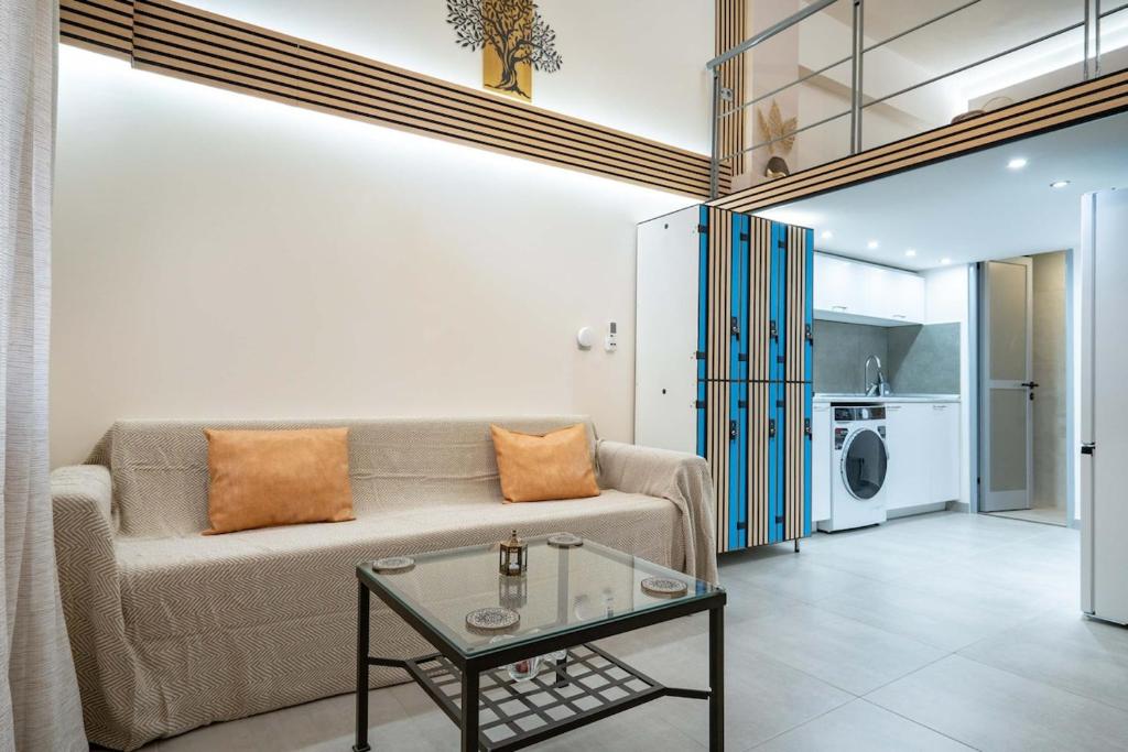 a living room with a couch and a table at Loft 53 - Twin Loft II by ΜΡS in Athens