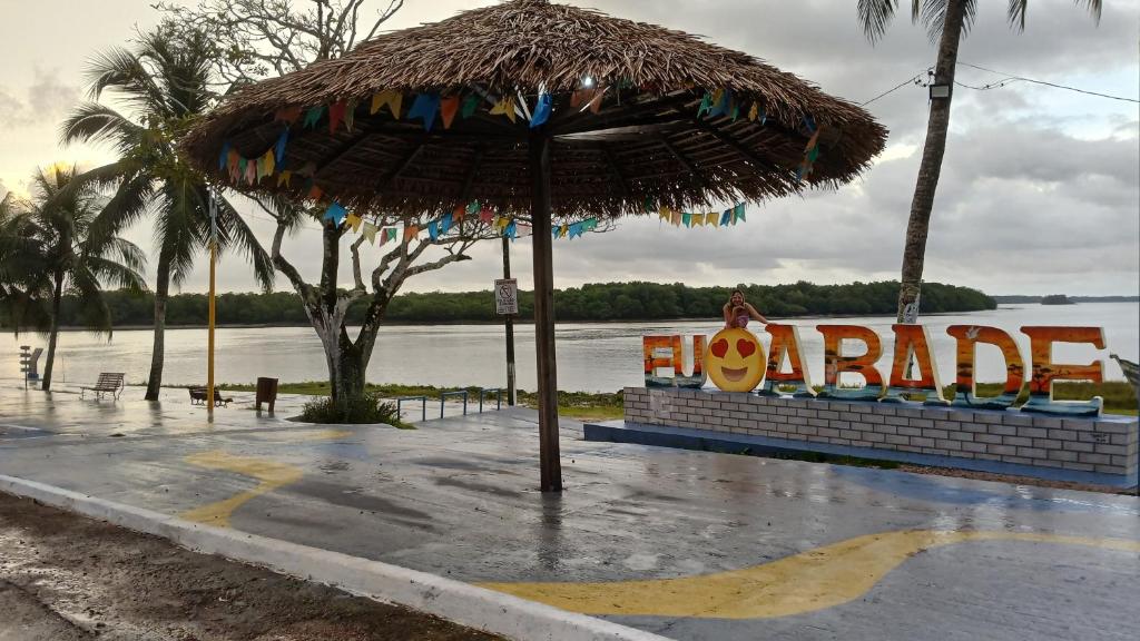 un grande ombrello di paglia davanti a un cartello di Varandas do Mar 