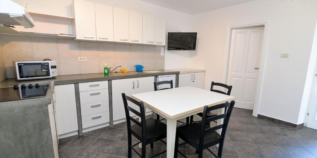a kitchen with a small table and a microwave at Mariana B4 in Veli Lošinj
