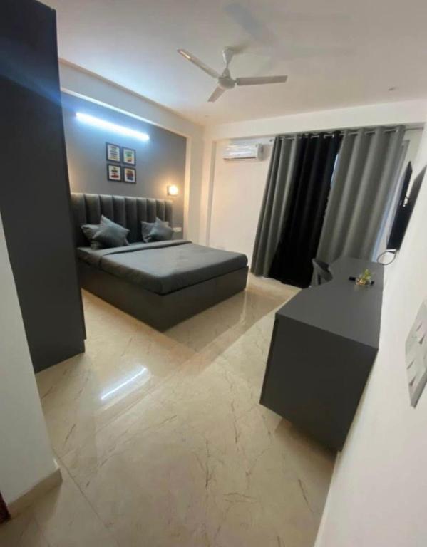 a living room with a bed and a table at Rusha Stays in Gumgaon
