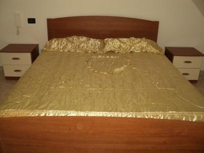 a bedroom with a bed covered in gold foil at Gaeta, vicino al mare in Gaeta