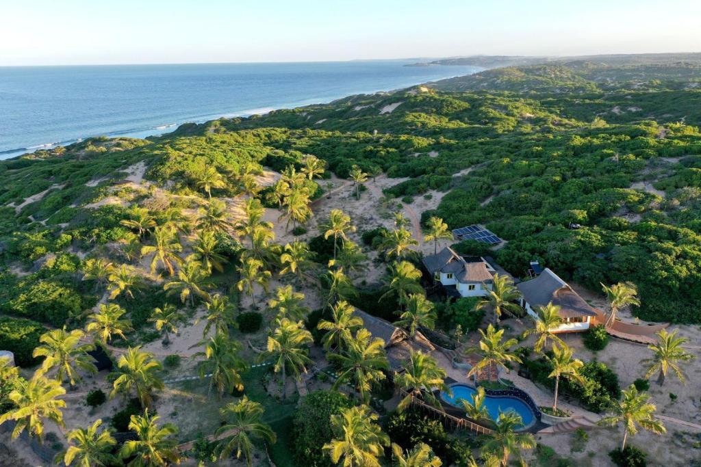 an aerial view of a resort with palm trees at Casa Hwinzo at Hwinzo Retreat, Tofo in Praia do Tofo
