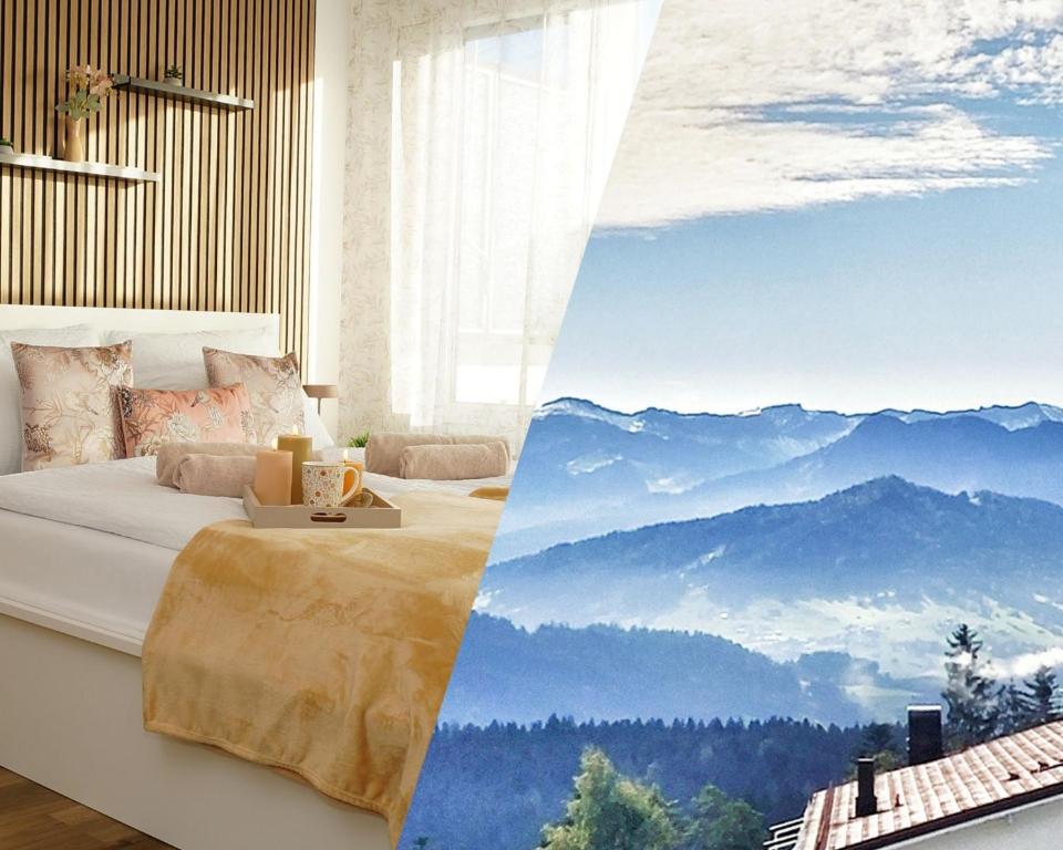 a bedroom with a bed with a view of mountains at RELAX - APPARTEMENTS mit Pool und Sauna, Allgäu in Scheidegg