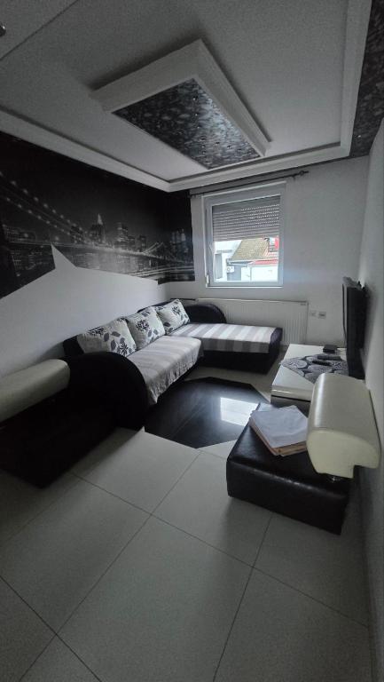 a living room with two beds and a couch at Tvrdjava Apartman in Petrovaradin
