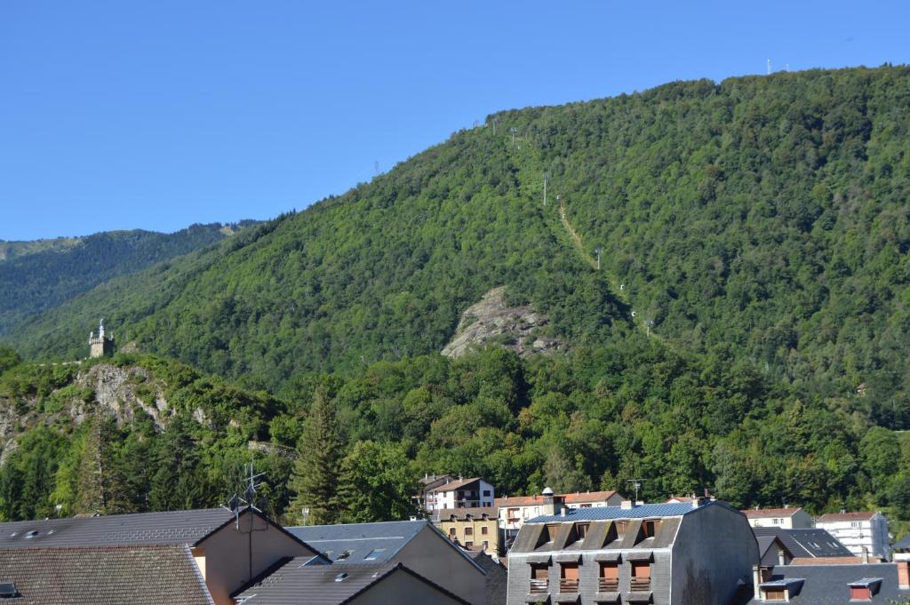 a town in front of a mountain at Hôtel Restaurant Le Bellevue in Ax-les-Thermes