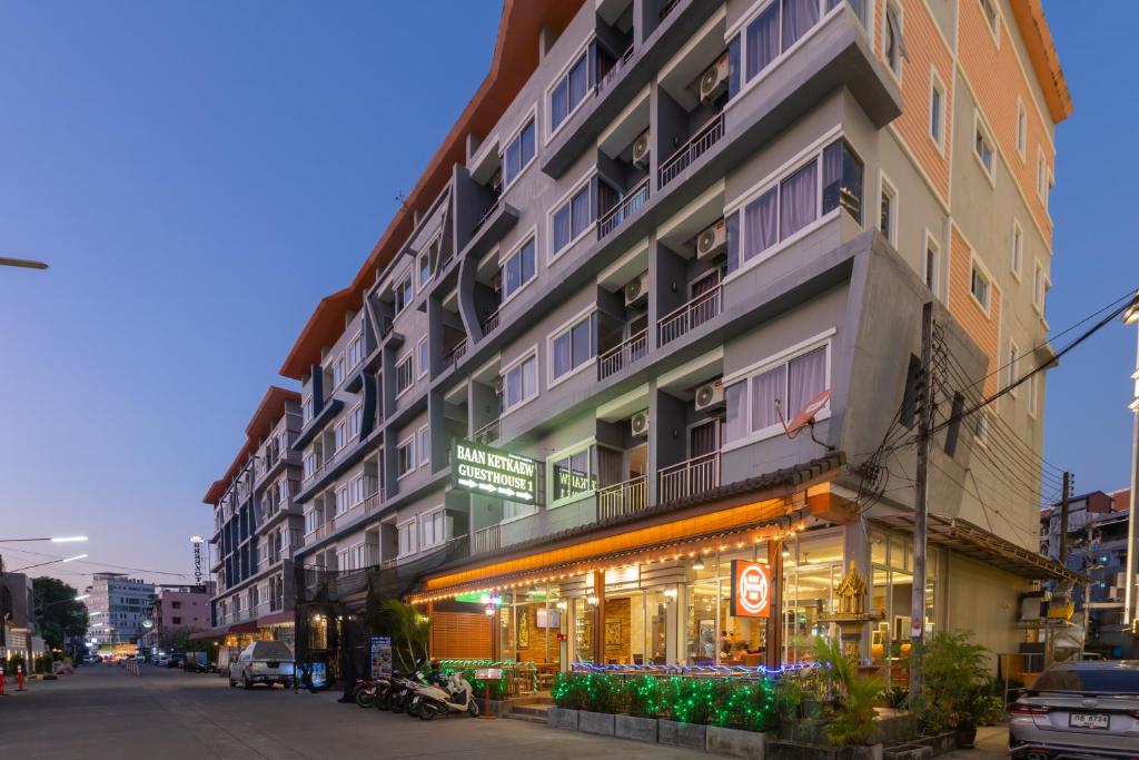 a tall building with a store in front of it at Baan KetKaew Patong in Patong Beach