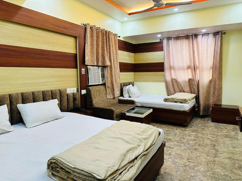 Postel nebo postele na pokoji v ubytování Hotel Anandam Residency