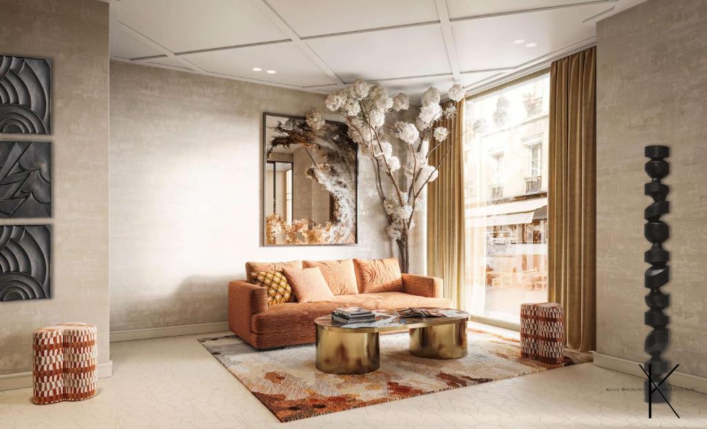 パリにあるJills Hôtelのソファとテーブルのあるリビングルーム