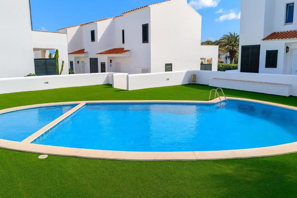 a large swimming pool in front of a house at Villa Chloe in Punta Grossa