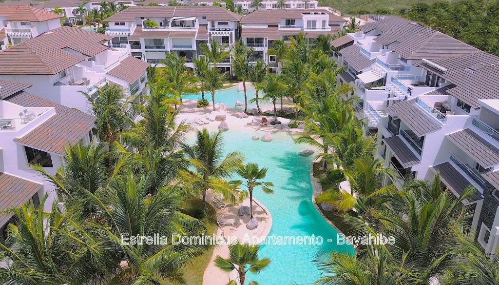 an aerial view of a resort with a pool and palm trees at Estrella Dominicus Apartamento - Bayahibe in Bayahibe