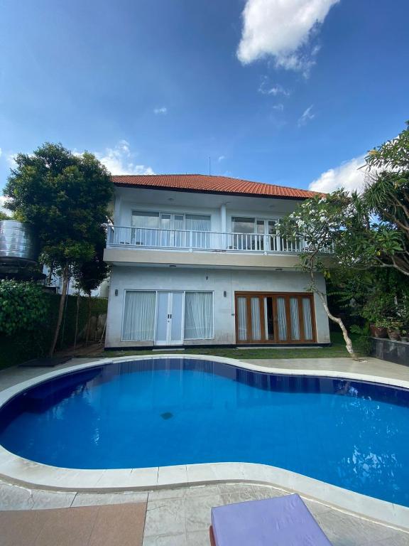 a large swimming pool in front of a house at Casavina residen kubu manyar 202 in Dalung