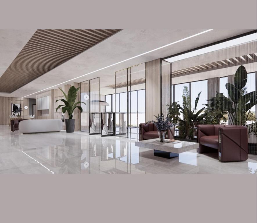a lobby with couches and plants in a building at TOROS BULVAR Cozy fancy Sea view next to the Beach and the Mall, in the mid of Alanya Mahmutlar! in Mahmutlar
