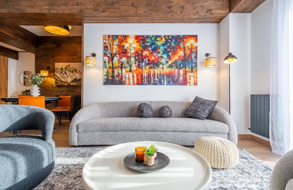 a living room with a couch and a painting at New Gudauri Ski4Life in Gudauri