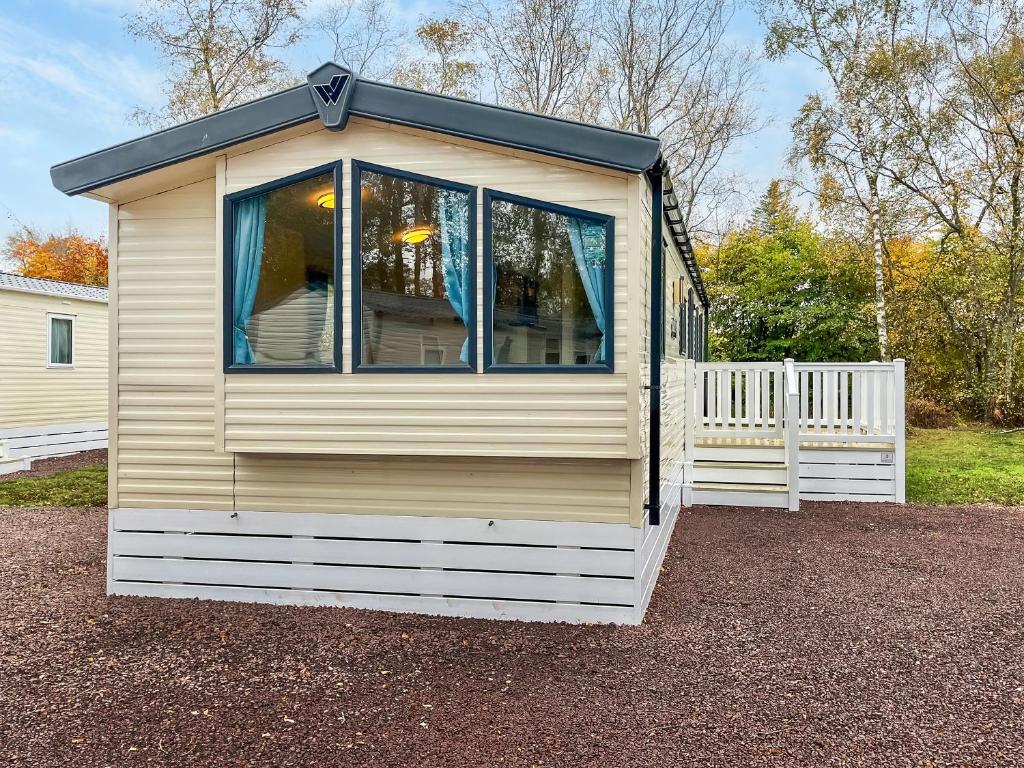 a house with a window on the side of it at Eskside Lodge in Edzell