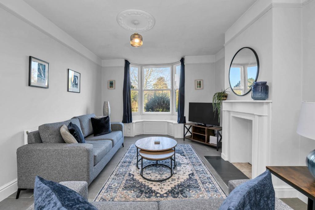 a living room with a couch and a table at 17 OutRisbygate St - 3 bedroom house that sleeps 6 with one private parking space in Bury Saint Edmunds