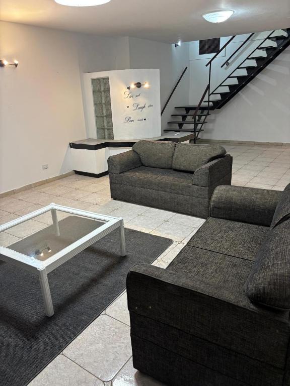 a living room with two couches and a coffee table at Shelly Bay House in Margate