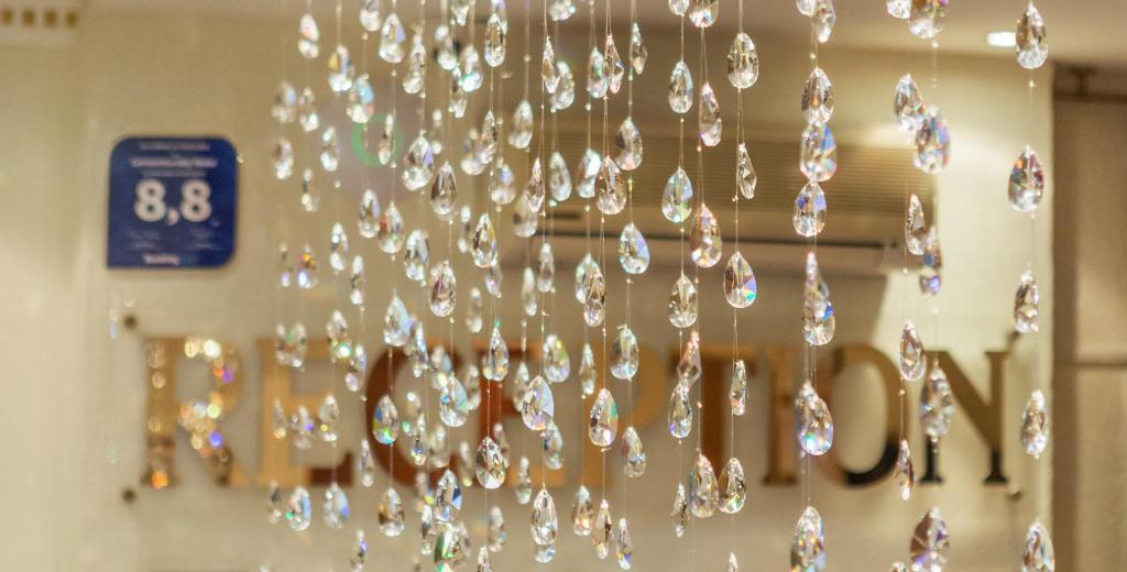 a chandelier hanging from a wall in a room at Shine Hotel in Odesa