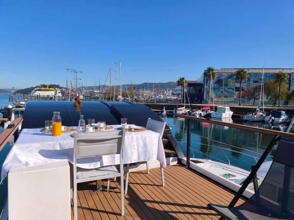 a table and chairs on the deck of a boat at Barco Different Charter - Experiencia Única en el Puerto Deportivo de Vigo in Vigo